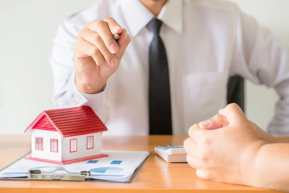 Businessman Discussing Home Purchase Loan with Client at Desk