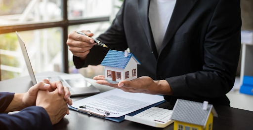 Businessman Presenting House Model to Client Discussing Mortgage Broker Services